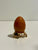 red egg on a decorative stand